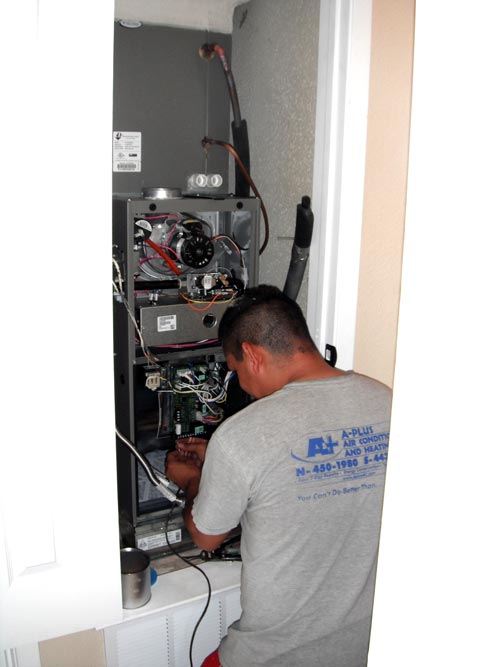 A-Plus Air Conditioning & Home Solutions - Technician working on a Furnace