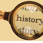 Magnifying glass focusing on "history" text, symbolizing exploration of handyman services for home maintenance.