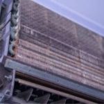 Close-up of an HVAC unit with metal coils and structure for energy-efficient solutions by A-Plus Air Conditioning.