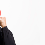 Individual in a red hat, smiling playfully, showcasing A-Plus Air Conditioning's home improvement services.
