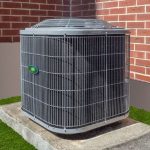 Air conditioning unit beside brick wall in outdoor space, highlighted for A-Plus Air Conditioning & Home Solutions services.