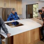 Team installing a kitchen feature in a modern home, highlighting A-Plus Air Conditioning's renovation expertise.