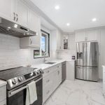 Modern kitchen with stainless steel appliances and marble countertop for home improvements by A-Plus Air Conditioning.