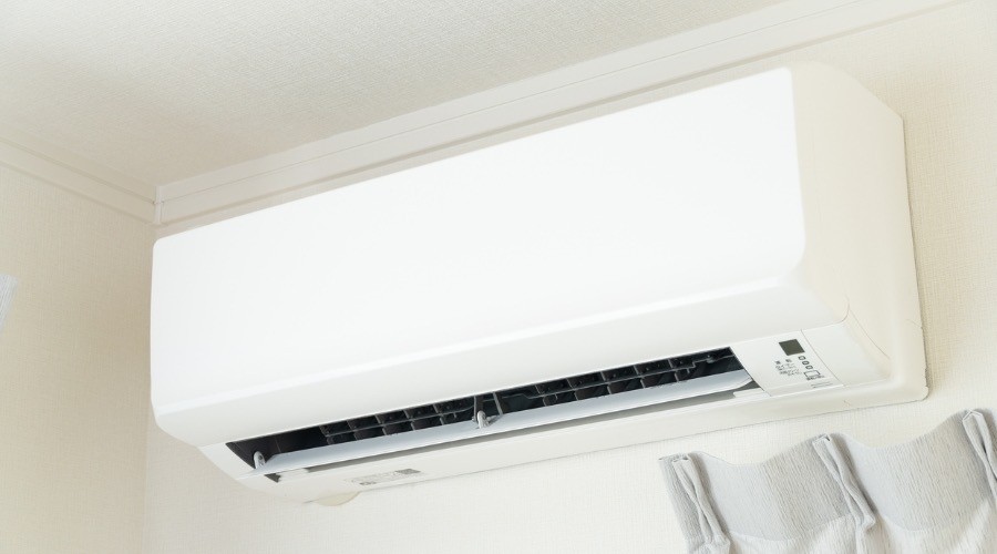 Ductless mini-split air conditioner mounted on a wall, illustrating modern HVAC solutions for energy efficiency and customized comfort.